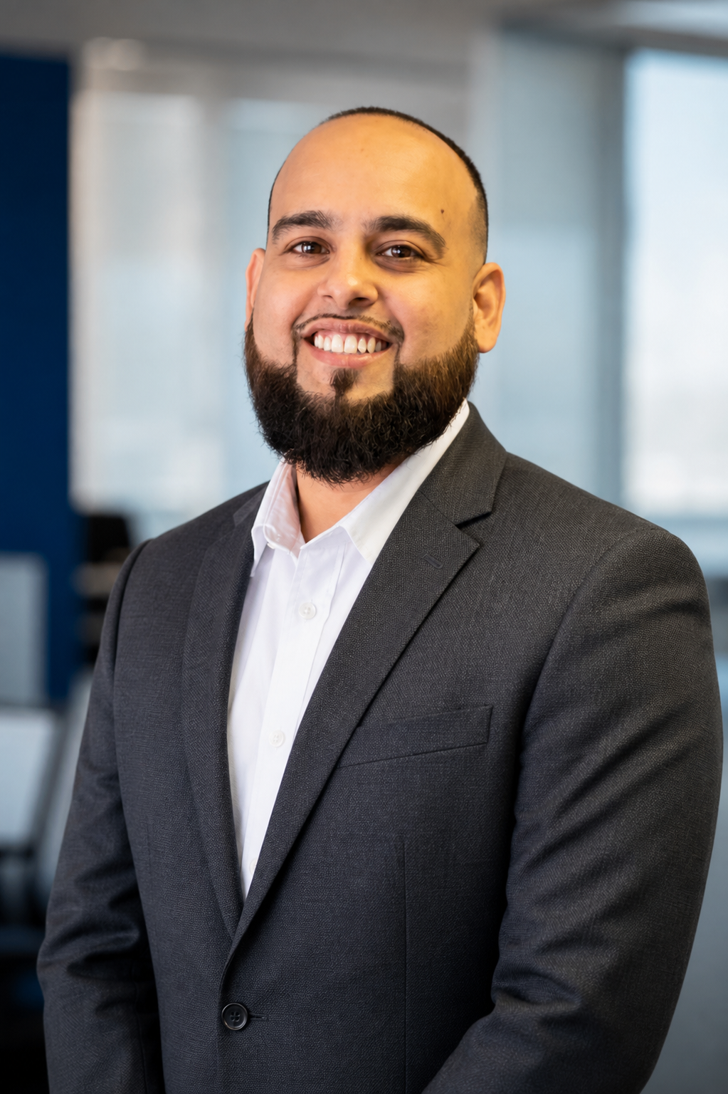 Ali, owner of Ali Insurance Agency LLC, in a professional office setting